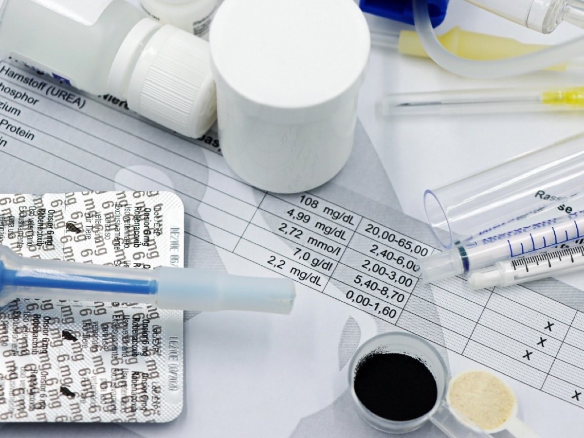 A printed lab result sheet with reference ranges among sample collection supplies — lab testing for Donna patients