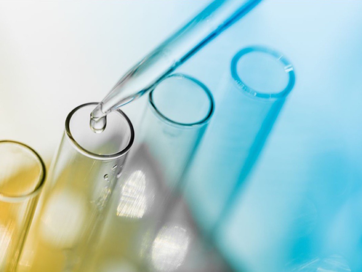 A pipette releasing a drop into glass test tubes — lab testing for McAllen patients