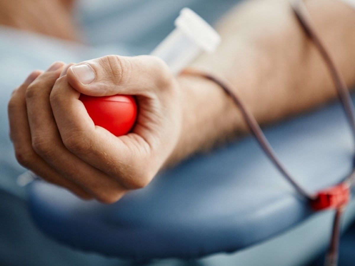 A patient's hand squeezing a grip ball during a blood draw — lab testing for Weslaco patients