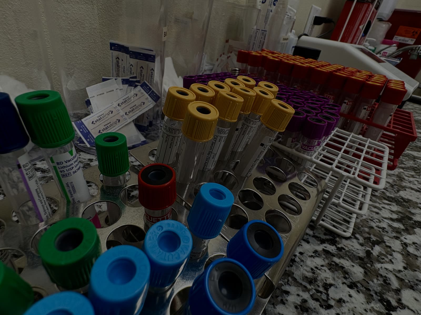 Blood collection tubes racked for lab testing at Surepointe Lab in Pharr, Texas